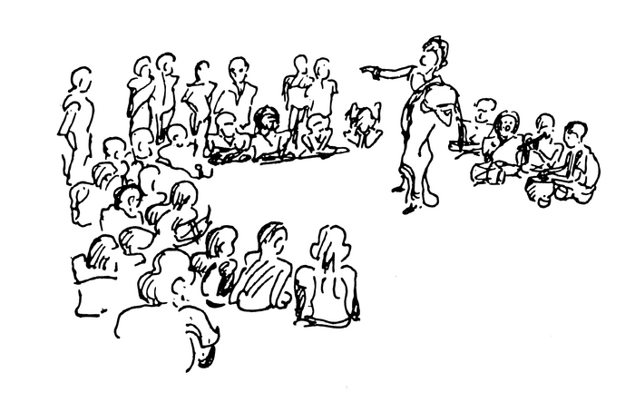 Seated meeting with speaker pointing